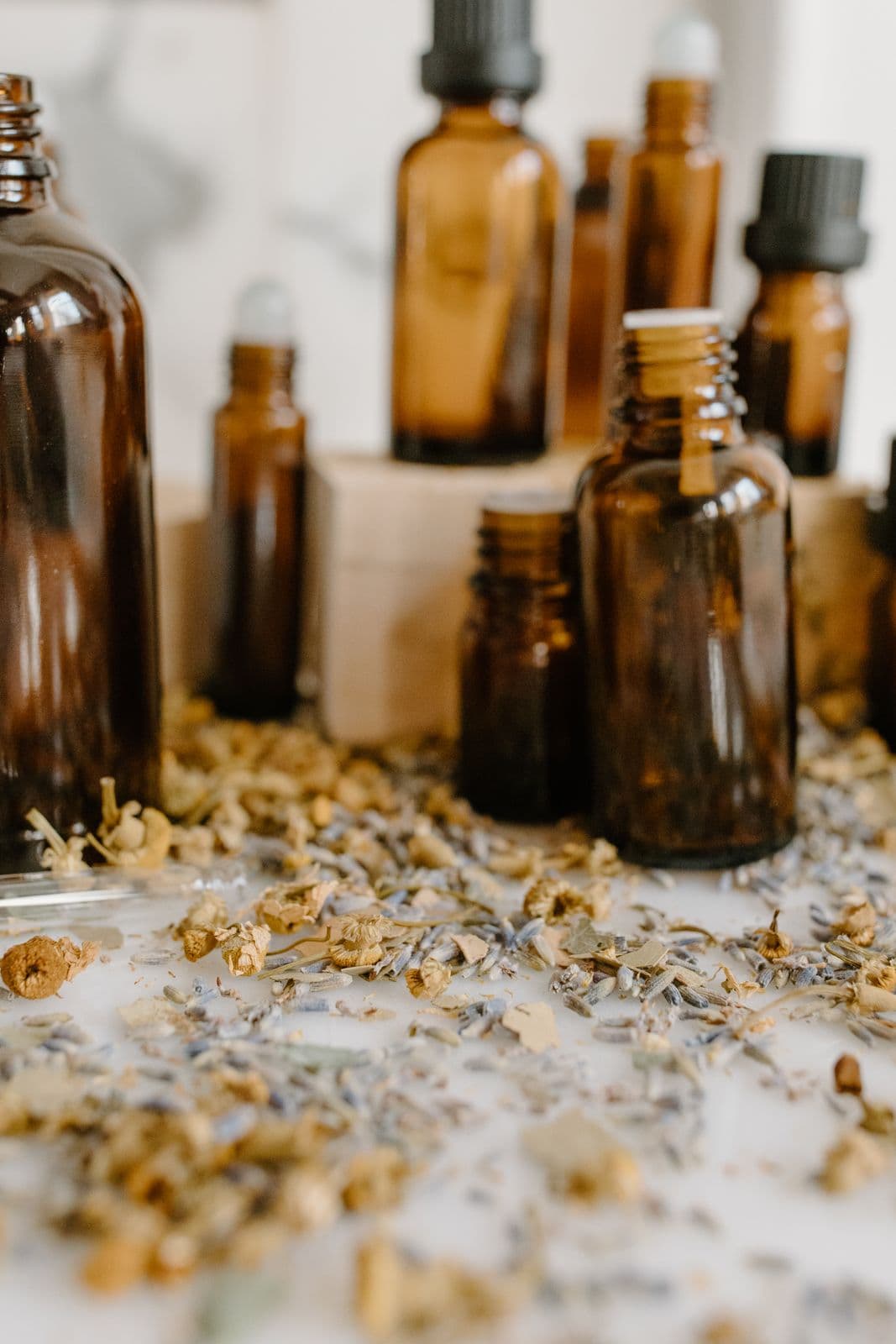 Amber glass bottles among dried flowers